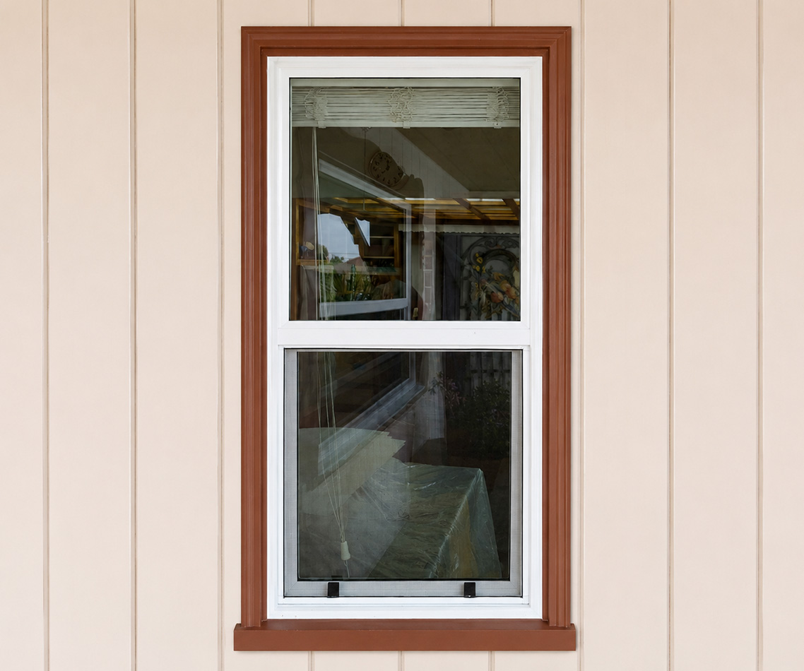 Single hung windows installed beside a walkway or patio area